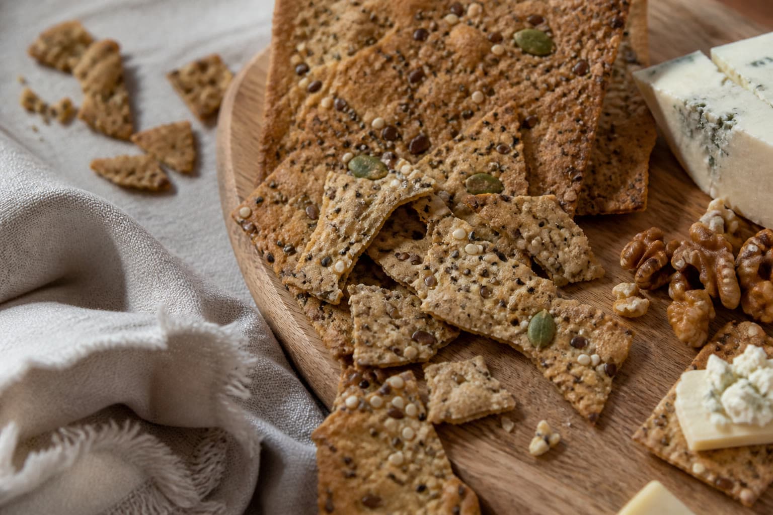 Shatter-thin seeded gluten-free sourdough discard crackers on parchment